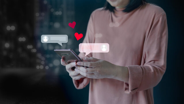 Concept for online dating or love correspondence, communicate on the Internet. Smart phone, connection internet love. Woman typing on mobile phone to sharing and commenting in online community.