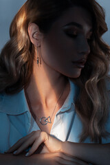 Portrait of a young woman with stylish jewelry with creative light