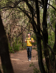 Fototapeta premium White man hiking through the forest in autumn.