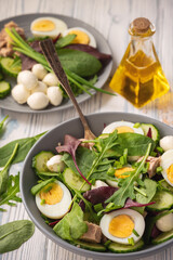 Obraz na płótnie Canvas Keto dish - healthy green salad with arugula, tuna, mozzarella and eggs. 