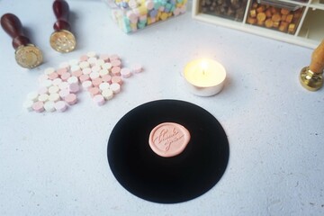 Pretty wax coins made from wax bead and stamp for a vintage look in letter or wedding invitation