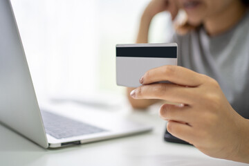 Stressed young woman with laptop and credit card. banking, shopping, money concept