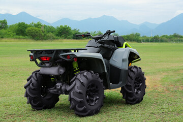 Modern quad bike on green grass outdoors © New Africa
