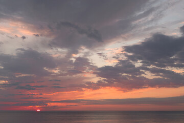 Calm sea with sunset sky with cloud.