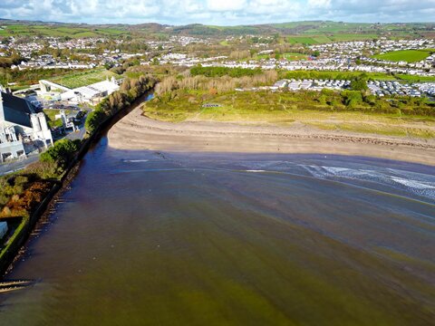 Scenic aerial shot of Par Beach in Cornwall. A costal town near the sea on a sunny day