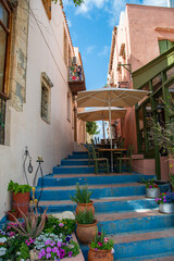 Blue stair steps leading up to a narrow street in Rethymno, Greece