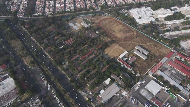 Aerial View Of Sports Track And Field Belonging To CCH Vallejo UNAM In Mexico City. Quick Circle Dolly