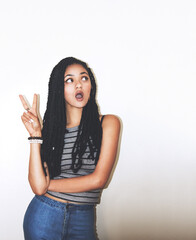 Obraz premium Black woman, peace and hand in studio for fun, attitude and fashion against a white background mockup. Hands, peace sign and girl on with vision, idea and vision, wow and surprise against mock up