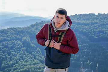 Young boy with backpack enjoying the freedom of the mountains and nature.