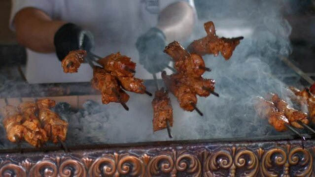 Making of Traditional Turkish meal kebab on barbeque.