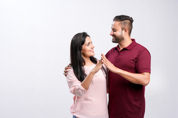 Indian couple making home symbol with hand on white background.