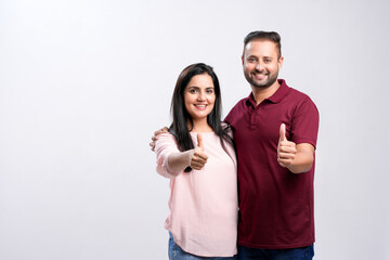 Happy indian couple on white background.