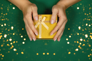 Gift of gold color on a green background.