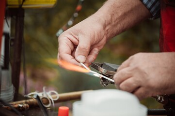 Glassblower blows handmade glass toys at craft festival