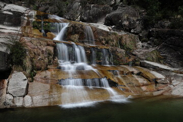 Fototapeta na wymiar A view of the Cascata Fecha de Barjas waterfalls in the Peneda-Geres National Park in Portugal