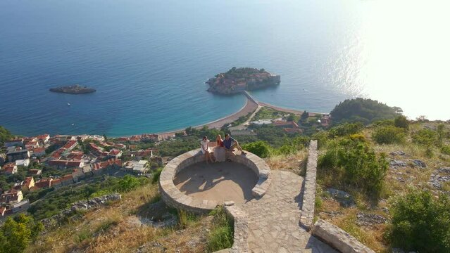 A group of friends visit the Saint Sava church which is located above the Sveti Stefan island near the city of Budva. Travel to Montenegro concept