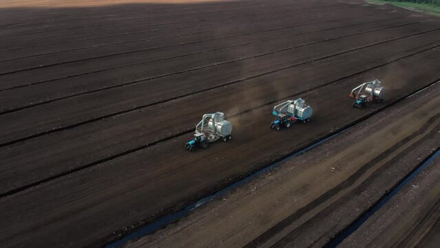 Drone shooting. Harvesting peat with combines. Peat extraction process. Agriculture industry.