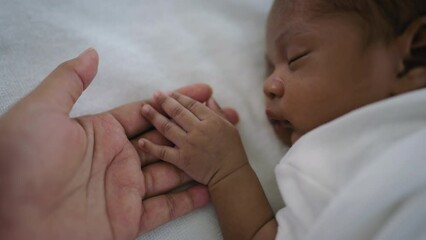 Parent hands holding newborn african black baby fingers, Close up mother's hand holding their new born baby. Together love family healthcare and medical, father's day and mother's day concept