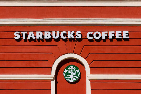 The logo sign of Starbucks Corporation is visible on a building in Piata Sfatului in the center of the Brasov city. Brasov city-Romania, 2022.