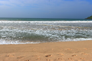 Fototapeta na wymiar Waves on Shore of Tropical White Sand Beach on a Sunny Day