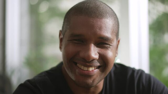 A joyful black man portrait face smiling. African American person