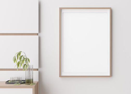 Blank vertical picture frame hanging on white wall. Template, mock up for your artwork, picture or poster. Empty, copy space. Close up view. Simple, minimalist mockup. 3D rendering.
