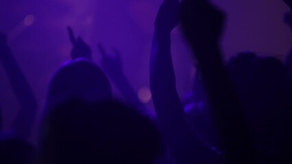 Silhouette, party or crowd in a dance concert dancing with freedom in crazy rock music festival at night. Audience, nightclub and excited people at a techno, rave or punk disco event together as fans