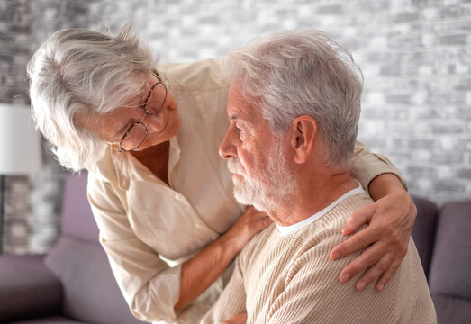 Old Worried Senior Woman Comforting Her Depressed, Mental Ill Husband, Unhappy Elderly Man At Home Need Medical Help. Ourmindsmatter