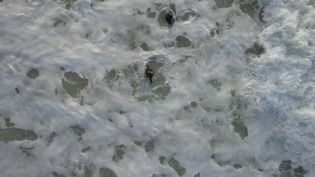 Foam drawn on waves with two people