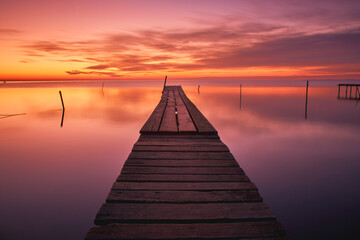 pontoon on the shore of the lake at sunrise