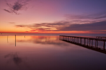 Fototapeta na wymiar pontoon on the shore of the lake at sunrise 02