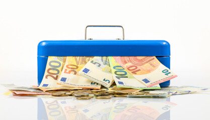 euro bills and coins lying on table and sticking out of blue cash box