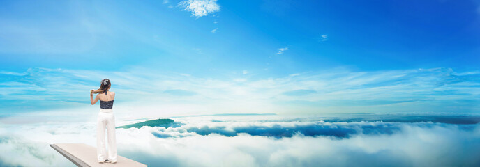 Beautiful girl, sexy dress, relaxing at the high cliff, relaxing in nature. Holiday tourism.	