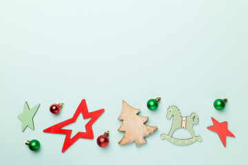 Wooden Christmas toys on color background, top view