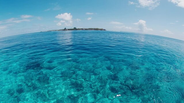 Calm sea surface during the sunny windless day in the Maldives