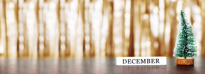 Christmas tree and word december on golden background with copy space. Merry xmas and Happy new...