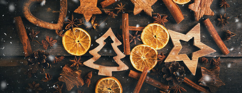 christmas decorations and spices on wooden background. banner