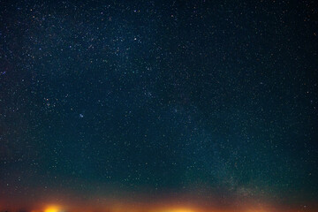 Obraz premium Amazing starry sky over city yellow lights. Space background with free copy space for design