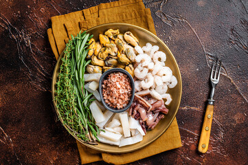 Seafood platter, mix of mussels, clams, squid, octopus, shrimps and prawn. Dark background. Top view