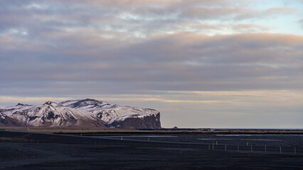 Amazing view of mountain and black sandy beach at sunset