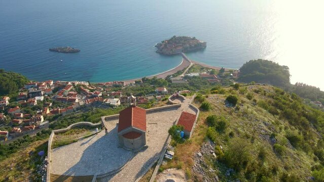 Aerial slowmotion video of the Saint Sava church which is located above the Sveti Stefan island near the city of Budva. Travel to Montenegro concept