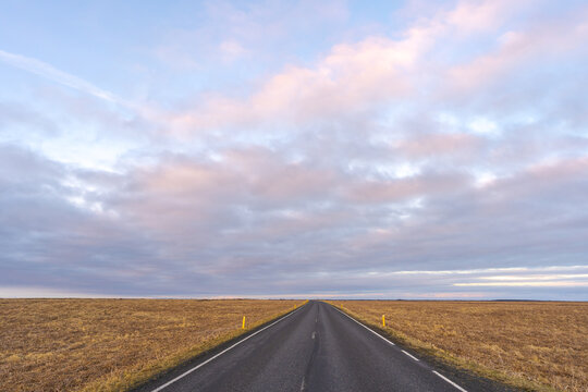 Asphalt road in countryside under sky