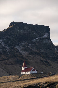 Reyniskirkja white church up on hill