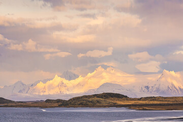 Frozen lake near snowy high mountains