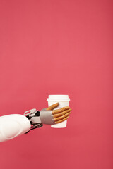 robot hand hold coffee on pink background.