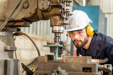 Team of engineers practicing maintenance Taking care and practicing maintenance of old machines in the factory so that they can be used continuously.