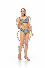 Measuring. Young attractive girl in drawn lingerie or underwear takes measurements isolated on...