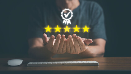 Man hand shows the sign of the top service with golden 5 star; Quality assurance , Guarantee, best...