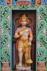 Indian monkey god Hanuman, devotee of Rama. A full-length figure of the hero of the Ramayana on the gate of a temple in Puri, Orissa, India. Vertical photo.