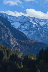 The peaks of Val Camonica with the first snow, glaciers, foliage and autumn colors, near the town of Ponte di Legno, Italy - October 2022.